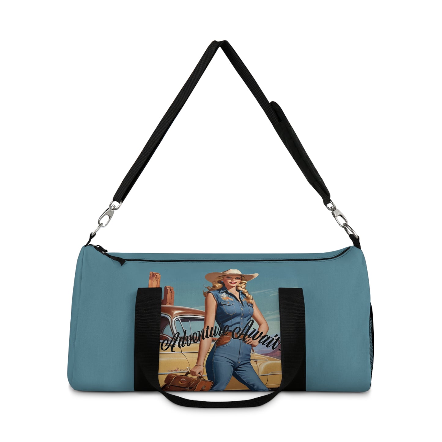 SMALL. Robin egg blue duffel bag with colorful retro cowgirl ready to roll through the SW United States. She's got her favorite bag and her trusty vintage sedan. Bag features black handles and a removable shoulder strap as well as a mesh exterior pocket. Available in two sizes.