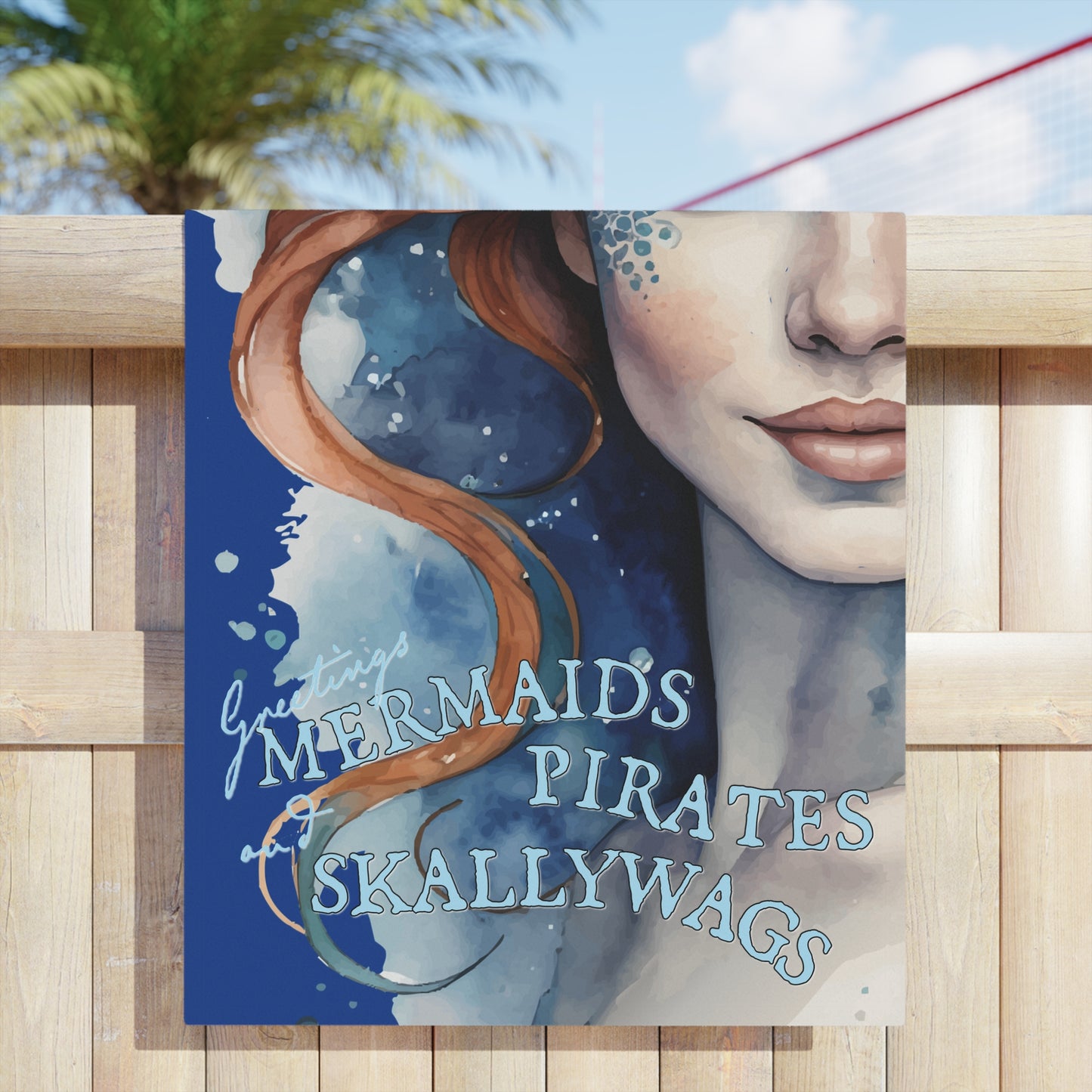 30" x 60"  Beach towel imprinted with a beautiful redhead ginger mermaid with blue eyes. Overlaid with "Greetings MERMAIDS PIRATES and SKALLYWAGS" Great at the pool, beach, travel, or at home.