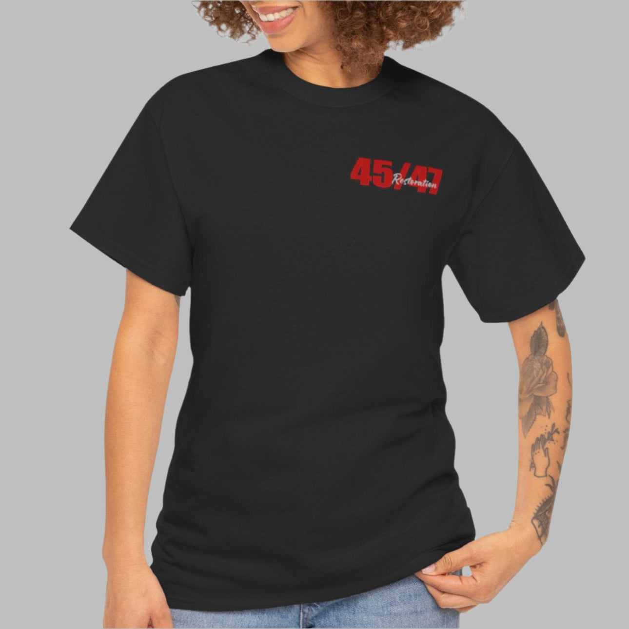 Cotton t-shirt imprinted in red with a gray overprint on the back of the names and strongest qualities of President Trump and his cabinet members / nominees. The front is imprinted on the left chest with 45/47 and the word Restoration overprinted in gray.