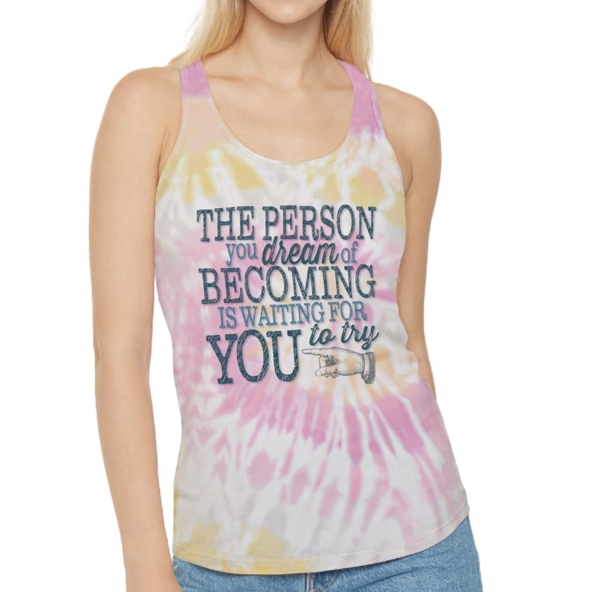 Model wearing a sunny yellow, pink, and white tie dye design racerback tank that is imprinted on the front with out inspirational and motivational slogan in a deep teal : The person you dream of becoming is waiting for you to try.