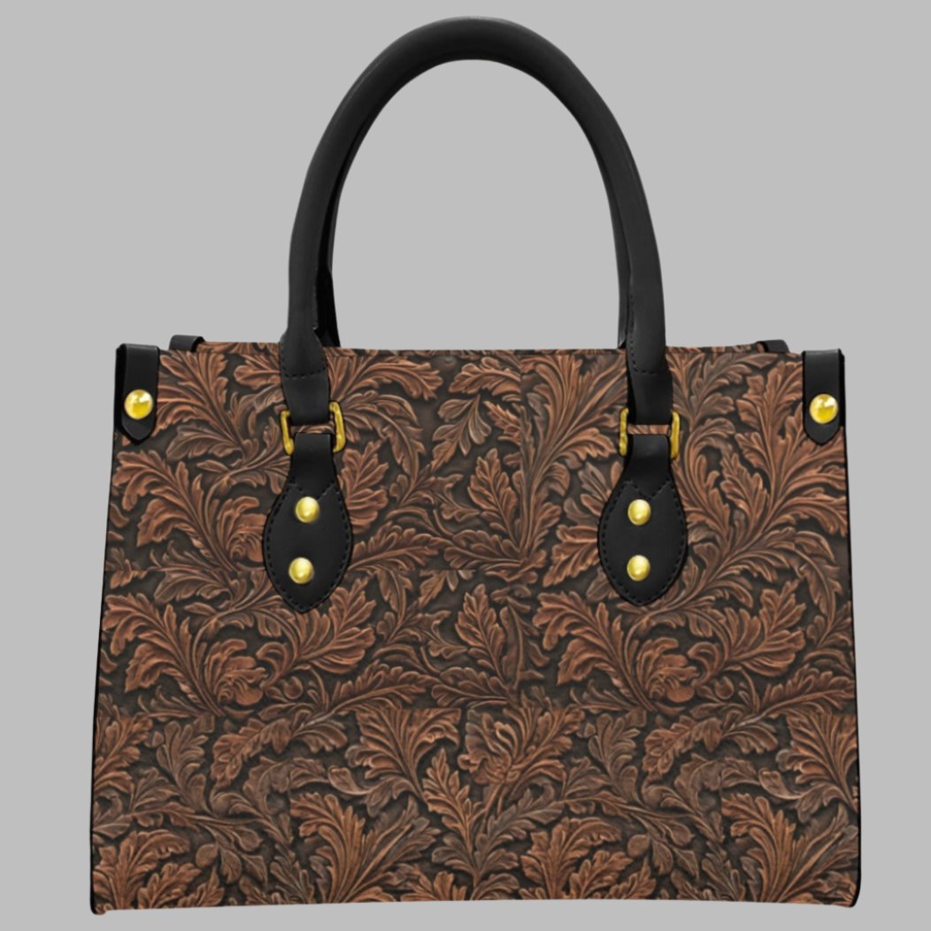 Vegan tooled leather print shoulder bag. Classic oak leaf pattern - with a twist. Black round handles and zipper closure. Makes a great gift for those who love the western lifestyle.