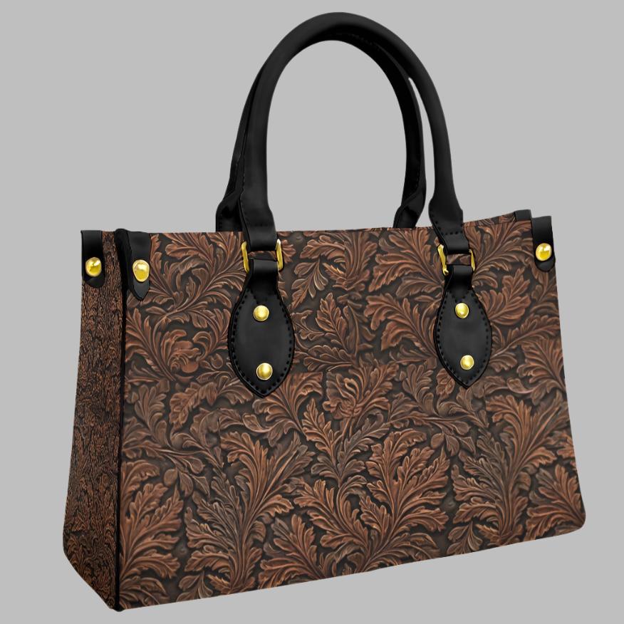Vegan tooled leather print shoulder bag. Classic oak leaf pattern - with a twist. Black round handles and zipper closure. Makes a great gift for those who love the western lifestyle.