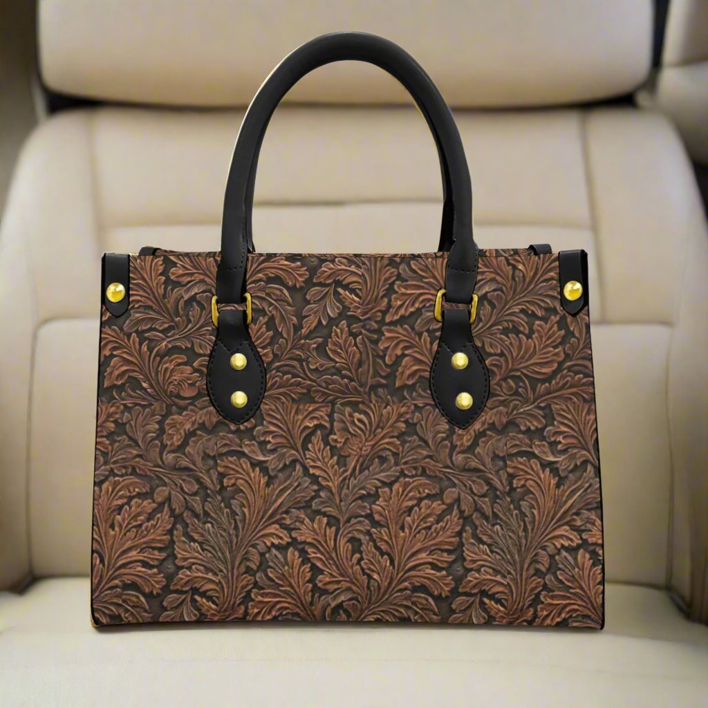 Vegan tooled leather print shoulder bag. Classic oak leaf pattern - with a twist. Black round handles and zipper closure. Makes a great gift for those who love the western lifestyle.