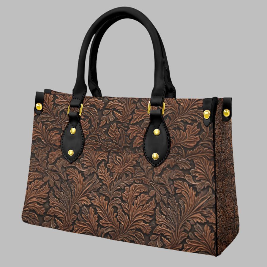 Vegan tooled leather print shoulder bag. Classic oak leaf pattern - with a twist. Black round handles and zipper closure. Makes a great gift for those who love the western lifestyle.