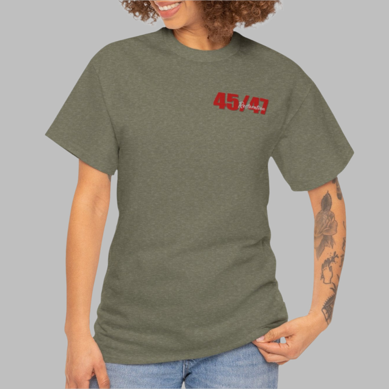 Cotton t-shirt imprinted in red with a gray overprint on the back of the names and strongest qualities of President Trump and his cabinet members / nominees. The front is imprinted on the left chest with 45/47 and the word Restoration overprinted in gray.