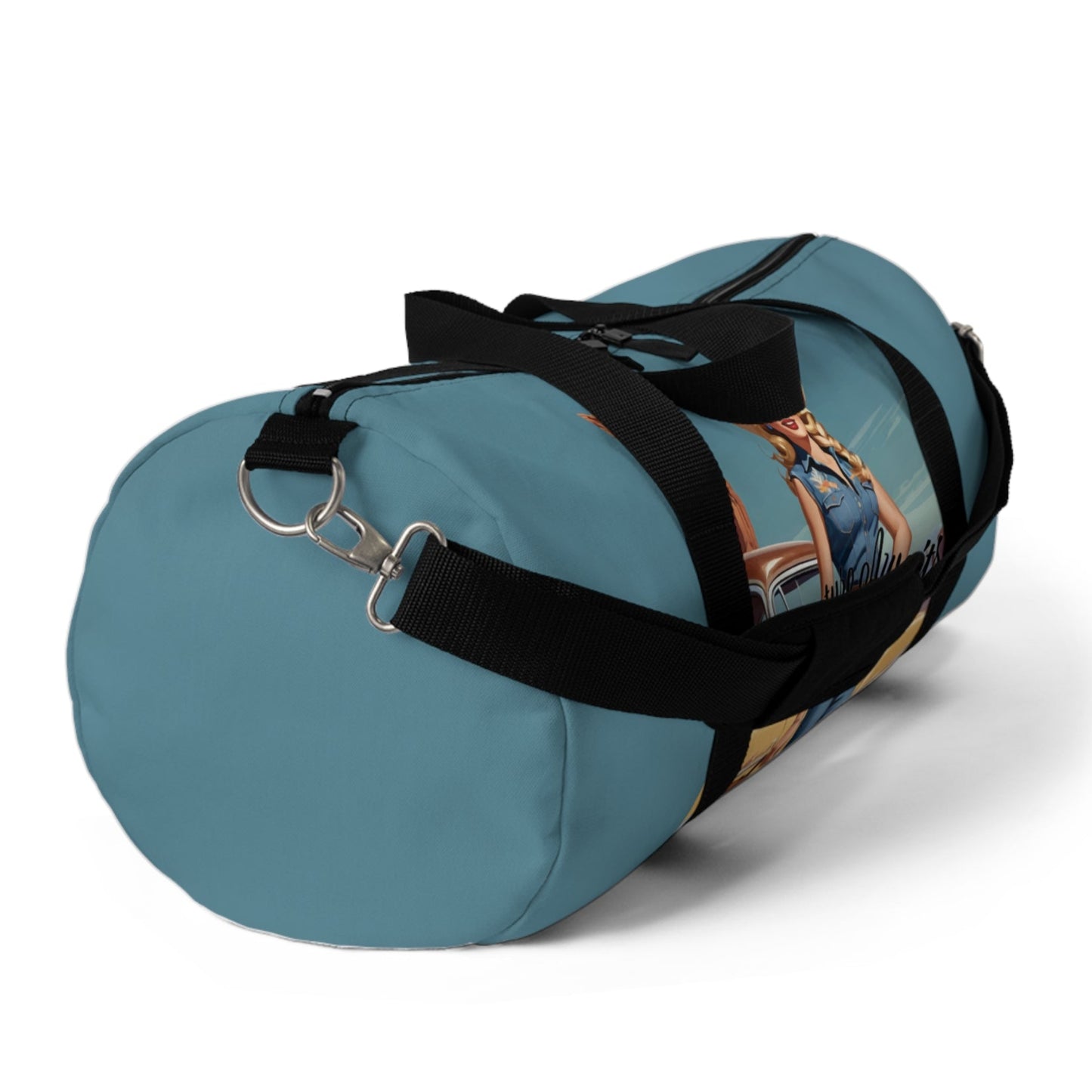 SMALL. Robin egg blue duffel bag with colorful retro cowgirl ready to roll through the SW United States. She's got her favorite bag and her trusty vintage sedan. Bag features black handles and a removable shoulder strap as well as a mesh exterior pocket. Available in two sizes.