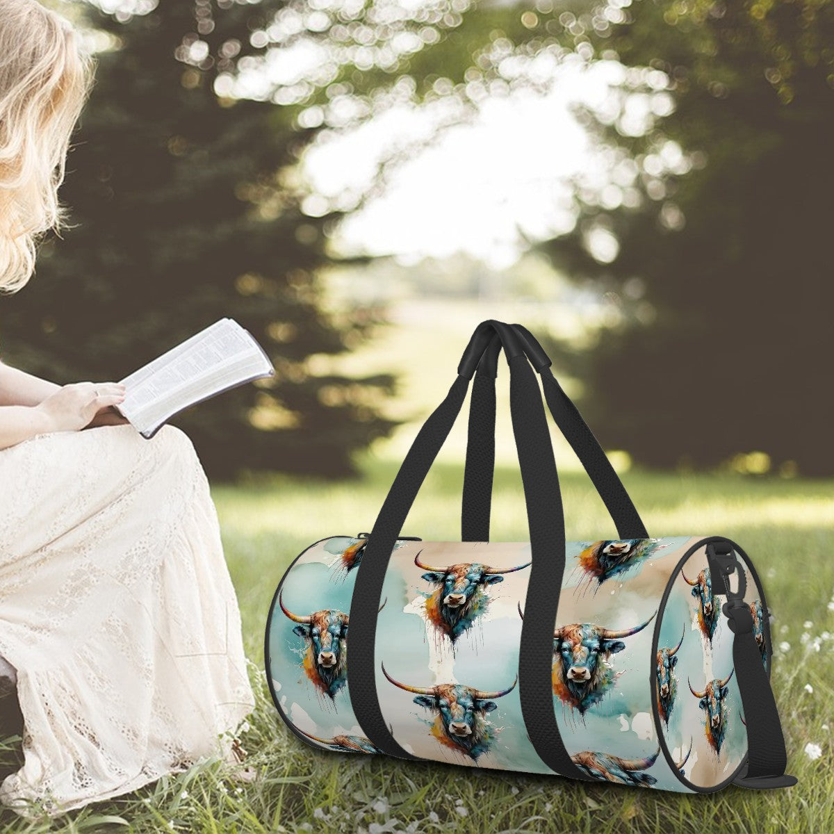 All over watercolor print in shades of turquoise, tan, and white overlaid with our colorful longhorn steer on a water-resistant poly canvas cylinder bag. Black webbing with faux leather grips. Removable nylon shoulder strap. Interior zipper pocket.
