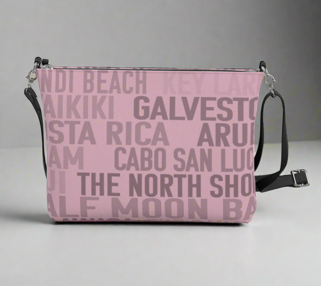 Pretty soft pink faux leather cross body bag with some of the warmest and most tropical places and beaches in the world slathered on both sides. 