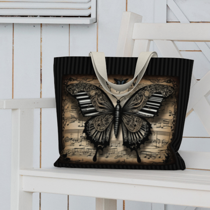 Ornate, gothic influence imprint of butterfly with piano key and steampunk influences over antiqued  sheet music and black on black stripes on a double-sided tote bag. 