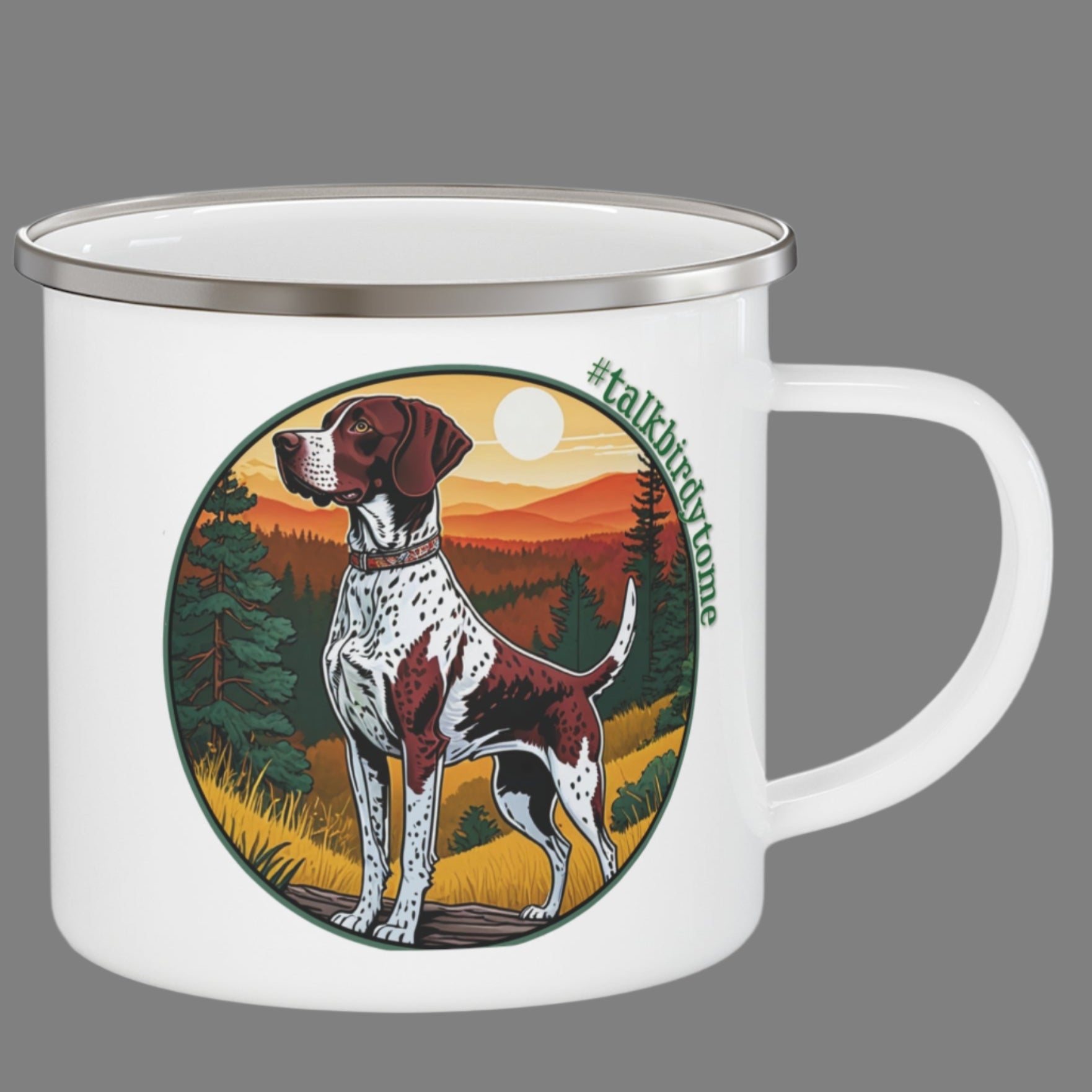 Enamel mug with imprint of German shorthaired pointer ready to go to work.  Shows dog at the ready and waiting to retrieve a bird. Pretty sunrise over distant mountains with golden grasses and green pine trees. Encircled with the tag line #talkbirdytome. White enamel coated stainless steel camping coffee mug. Same imprint on both sides.