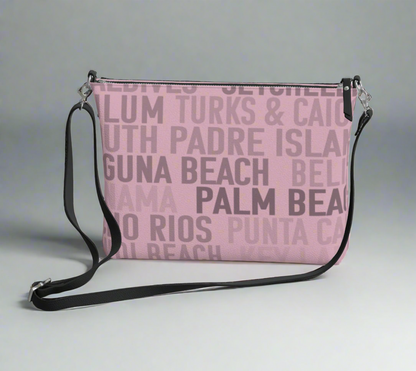 Pretty soft pink faux leather cross body bag with some of the warmest and most tropical places and beaches in the world slathered on both sides. 