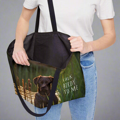 Large weekender style canvas tote bag imprinted both sides with our exclusive image of an intense chocolate Labrador Retriever duck hunting dog waiting near the reeds and cattails.  It reads TALK BIRDY TOME. Imprinted the same n both sides. Woven cotton handles.