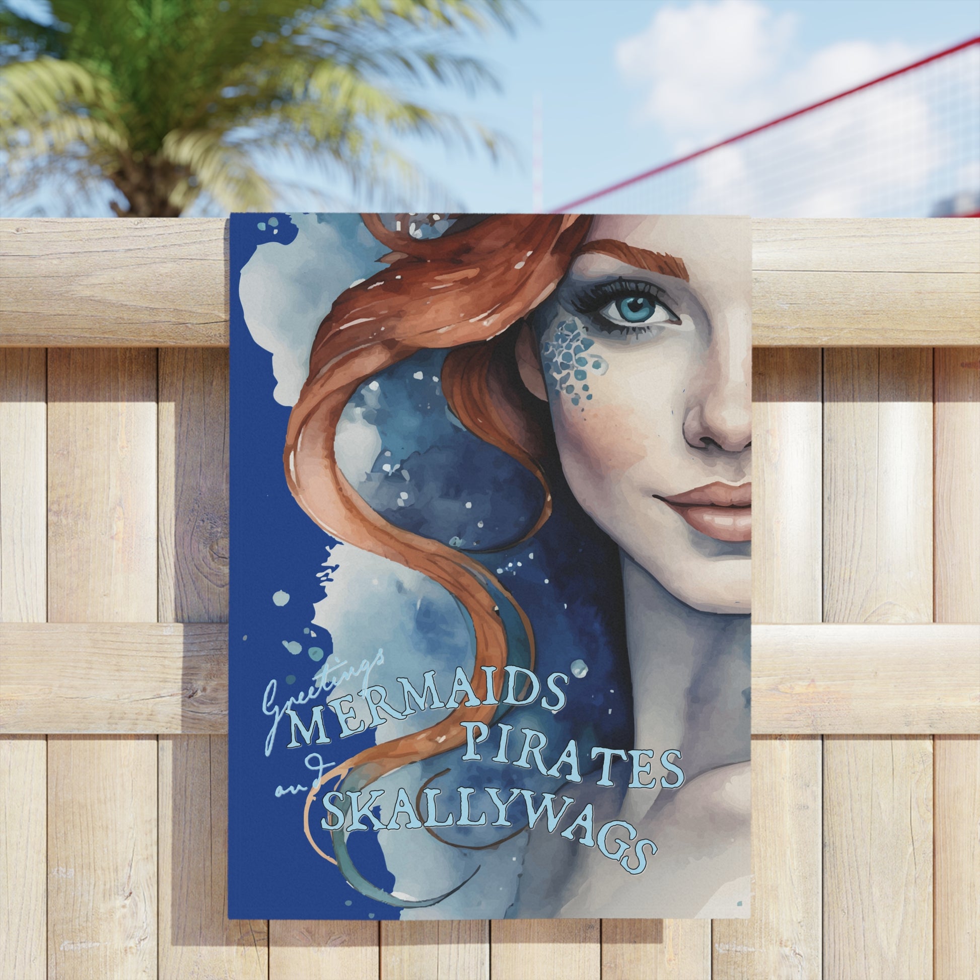 24" x 44" Beach towel imprinted with a beautiful redhead ginger mermaid with blue eyes. Overlaid with "Greetings MERMAIDS PIRATES and SKALLYWAGS" Great at the pool, beach, travel, or at home.