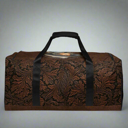 Oversize duffle bag imprinted with classic western tooled-leather look on sides and ends. Pebble leather print on tops and bottom. Peaceful cowgirl and Bible verse imprinted on top flap. Black carrying straps and handles. Bag has exterior mesh pocket on one end and multiple interior pockets. 