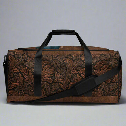 All-over print western tooled leather imprint duffle bag. Black carry straps and handles. Mesh exterior pocket. Imprinted with pretty cowgirl and Proverb about wisdom and good judgment being more valuable that silver and gold. 