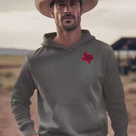 Charcoal gray hoodie sweatshirt imprinted with a red shape of Texas on the chest which has a (R) over the top. Model is a handsome< rugged cowboy in a western hat.  Video created with AI.