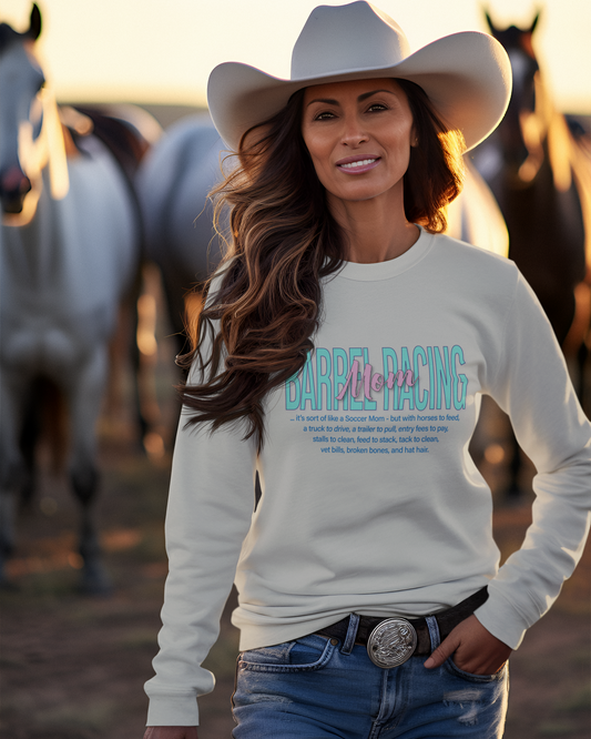 Woman in long sleeve crew neck pullover sweatshirt imprinted with Barrel Racing Mom on the front. 